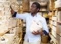 African american shopper choosing storage wicker basket at store