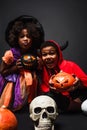 african american siblings in costumes holding