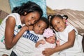 African American Siblings Hugging On Floor