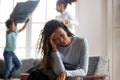 African mom feels tired of noisy children playing at home Royalty Free Stock Photo