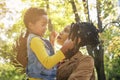 African American single mother and her daughter in meadow together having conversation. Royalty Free Stock Photo