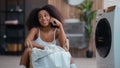 African American smiling happy woman biracial ethnic female girl lady housewife housekeeping sit on floor talking mobile Royalty Free Stock Photo