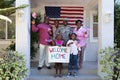 African american soldier father with smiling wife, children and parents in front of their home Royalty Free Stock Photo