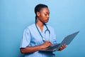 African american specialist assistant holding laptop computer typing disease expertise