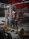 African american sports guy with muscular torso training with barbell in gym. Weightlifting, strength training Royalty Free Stock Photo