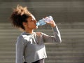 African american sports woman drinking from water bottle Royalty Free Stock Photo