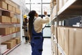 African american storehouse manager checking parcels maintenance