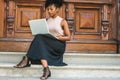 African American Student studying in New York, with afro hairstyle, wearing sleeveless light color top, black skit, strappy Royalty Free Stock Photo