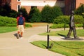 An African American student walks by the James Meredith Statue Royalty Free Stock Photo