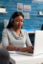 African american student wearing headset browsing online information working at communication webinar