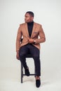 African american stylish business man at the workspace office on white background in studio shot. well-dressed model