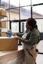 African american supervisor preparing packages for delivery