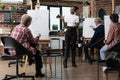 African american teacher giving advice to students explaining sketching technique