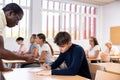 African american teacher prompts an adult student to solve equation Royalty Free Stock Photo