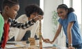African American teacher and student doing activity playing block wooden for development together with enjoy and fun in the Royalty Free Stock Photo