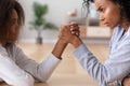 African American teen daughter and mother arm wrestling family conflict