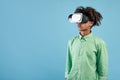 African american teen guy wearing VR headset, using virtual reality for entertainment, exploring cyberspace, free space Royalty Free Stock Photo