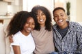 African American teen and young adult brother and sisters smiling to camera, close up