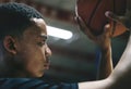 African American teenage boy concentrated on playing basketball Royalty Free Stock Photo