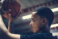 African American teenage boy concentrated on playing basketball Royalty Free Stock Photo