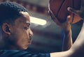 African American teenage boy concentrated on playing basketball Royalty Free Stock Photo