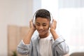 African-American teenage boy listening to music with headphones Royalty Free Stock Photo