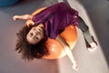 African american teenage girl smiling at camera while working out with exercise ball in gym. Sport, healthy lifestyle Royalty Free Stock Photo