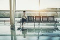 Brazilian girl looking at camera while waiting in airport terminal Royalty Free Stock Photo