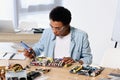 african american teenager soldering computer circuit with soldering iron