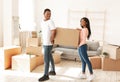 African American tenants carrying cardboard box with belongings in new home Royalty Free Stock Photo