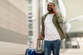 African American Traveler Guy Talking On Phone Walking In Airport