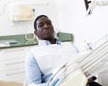 African American waiting for checkup in chair at dental clinic Royalty Free Stock Photo