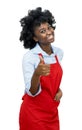 African american waitress with red apron showing thumb up