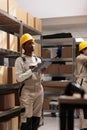 African american warehouse manager making freight overview in stockroom