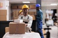 African american warehouse operator managing parcels receiving portrait
