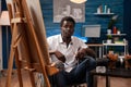 African american wheelchair user working at art studio