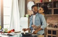African-american wife kissing husband in kitchen Royalty Free Stock Photo
