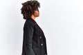 African american woman with afro hair wearing business jacket and glasses looking to side, relax profile pose with natural face Royalty Free Stock Photo