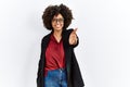 African american woman with afro hair wearing business jacket and glasses smiling friendly offering handshake as greeting and Royalty Free Stock Photo