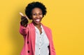 African american woman with afro hair wearing business jacket smiling friendly offering handshake as greeting and welcoming Royalty Free Stock Photo