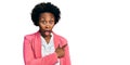 African american woman with afro hair wearing business jacket surprised pointing with finger to the side, open mouth amazed Royalty Free Stock Photo