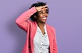 African american woman with afro hair wearing business jacket very happy and smiling looking far away with hand over head Royalty Free Stock Photo