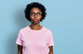 African american woman with afro hair wearing casual clothes and glasses relaxed with serious expression on face Royalty Free Stock Photo