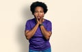 African american woman with afro hair wearing casual purple t shirt tired hands covering face, depression and sadness, upset and