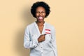 African american woman with afro hair wearing hello my name is sticker identification sticking tongue out happy with funny Royalty Free Stock Photo