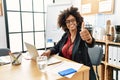 African american woman with afro hair working at the office wearing operator headset approving doing positive gesture with hand, Royalty Free Stock Photo