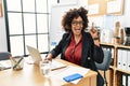 African american woman with afro hair working at the office wearing operator headset pointing finger up with successful idea Royalty Free Stock Photo