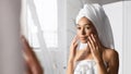 African American Woman Applying Eye Cream Standing Near Mirror, Panorama