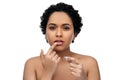 african american woman applying lip gloss Royalty Free Stock Photo