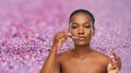 African american woman applying lip gloss Royalty Free Stock Photo